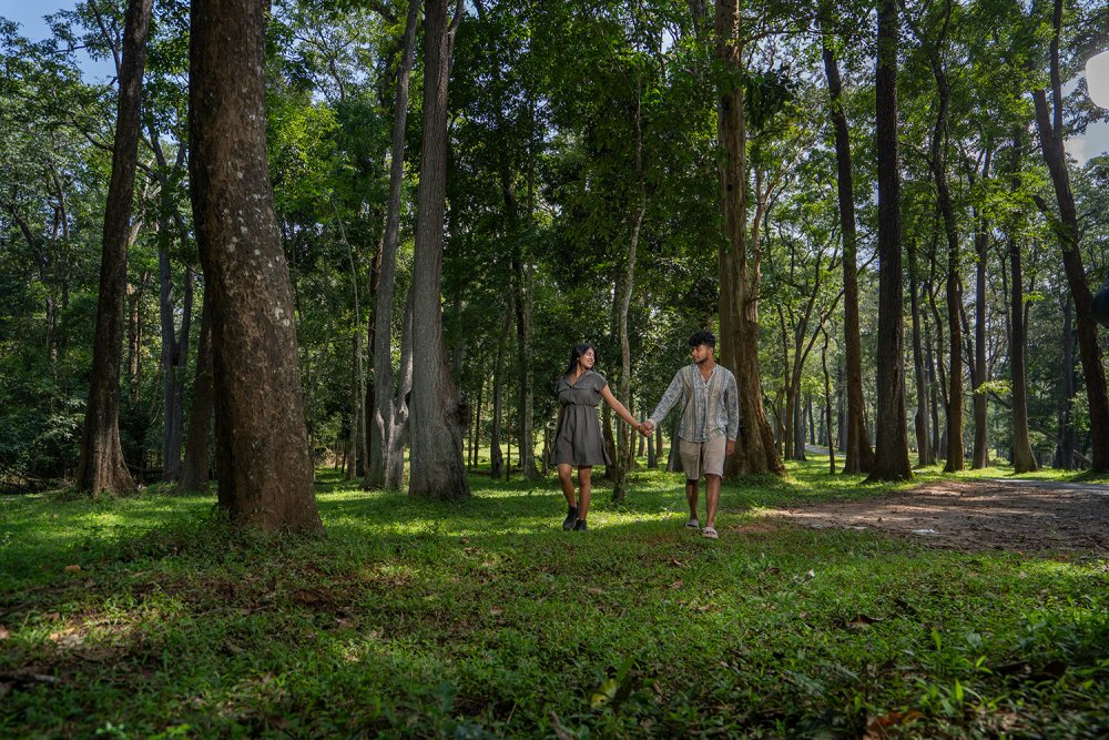 Couple walking through lush greenery at Kuruva Island